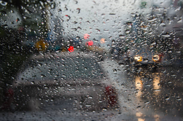 istock Rain drop on traffic jam and electric light in the night. blur abstract background. 907469798