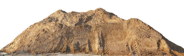 A large pile of construction sand with traces of tractor wheels. A large pile of construction sand with traces of tractor wheels. Isolated on white outdoor shot building sand stock pictures, royalty-free photos & images