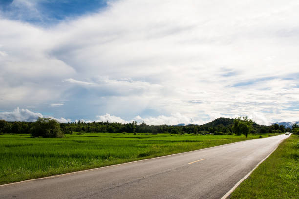istock Asphalt road and cloud sky with green trees 907472686