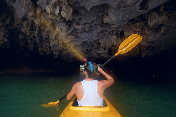 istock Woman paddling the kayak inside karst cave 907472718