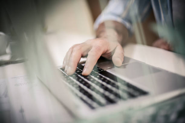 istock Business senior man typing on laptop. Close up. 907473522