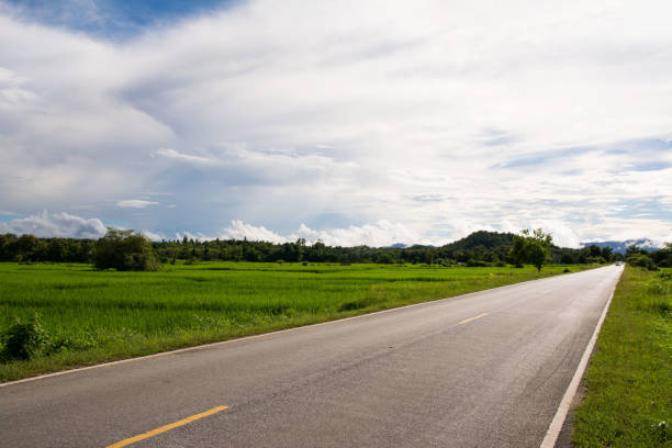 istock Asphalt Road in the field and clouds sky 907479478