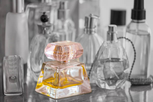 istock corlored perfume bottle on monochrome background 907479682