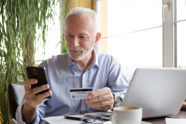 istock Senior man paying bills online 907485344