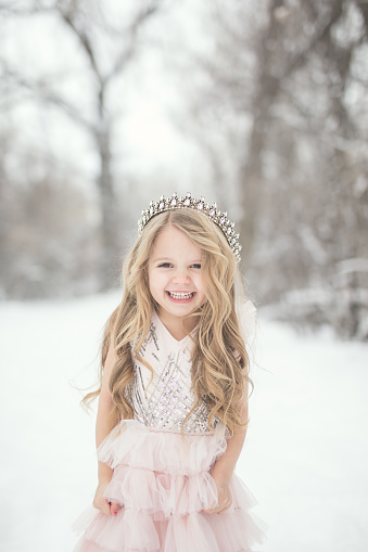 Portraits of a 4 year old little girl in the snow.
