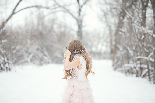 Portraits of a 4 year old little girl in the snow.