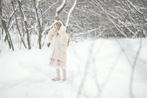 Portraits of a 4 year old little girl in the snow.