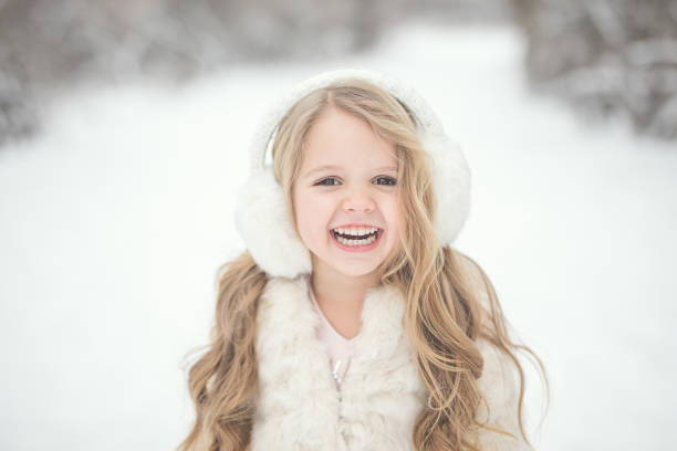 Portraits of a 4 year old little girl in the snow.