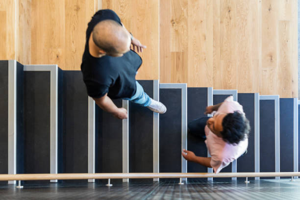 istock High Angle View of Casually Dressed Business People on Stairs 907504306