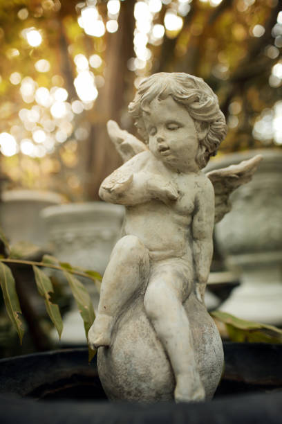 istock Cupid sculpture in garden. 907507266