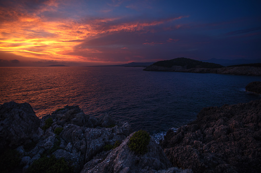 Beautiful sunset over rocky cape. Peloponnese, Greece.