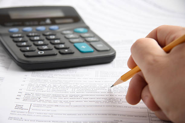 istock Filling the form with a pencil next to a calculator 90751433