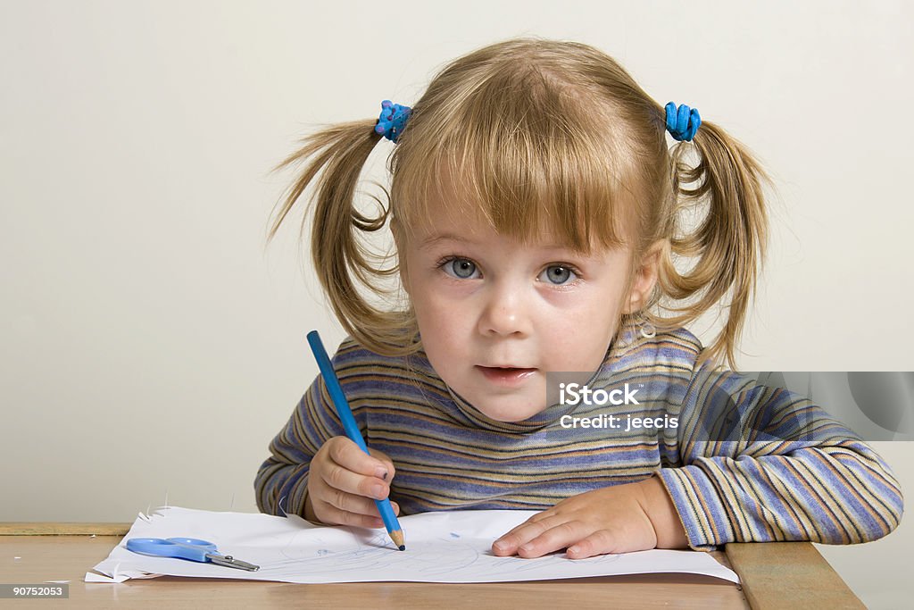 A small white child looking up from a drawing young pretty girl learn drawing with blue pen Beauty In Nature Stock Photo