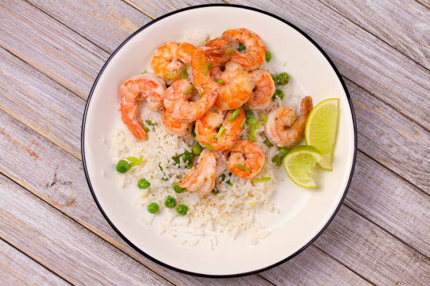 istock Shrimps with rice and peas 907543724