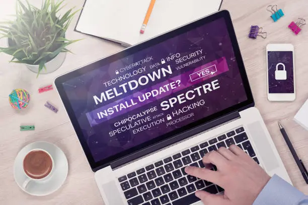 Photo of Installing update against meltdown and spectre threat concept on top view laptop screen