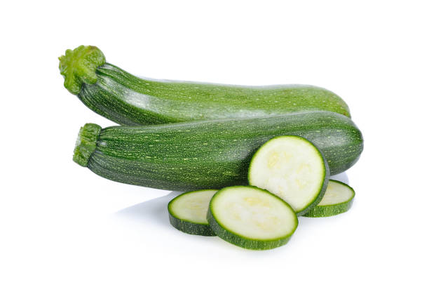 istock whole and sliced fresh zucchini on white background 907549316