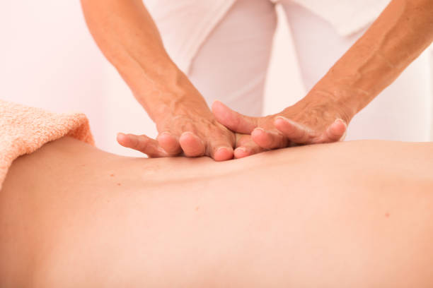 istock Massage Therapist Giving a Reiki Back Massage 907559134
