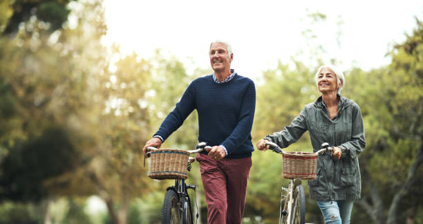 the park is our favorite place to cycle through - candid people casual bicycle imagens e fotografias de stock