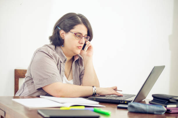 Adult Woman Using Mobile Phone in Office.