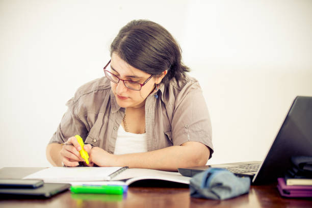istock Adult Woman Working and Taking Notes in Office 907563524