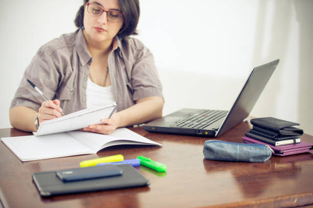 istock Adult Woman Working and Taking Notes in an Office 907563580