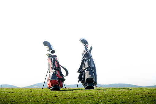 Two Golf Bags on Meadow