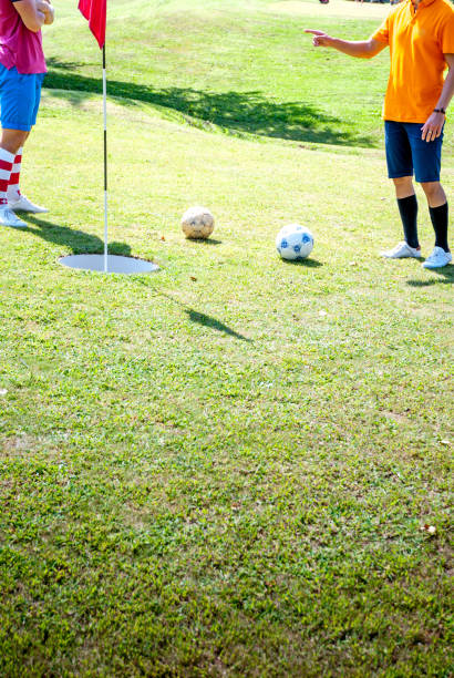 istock Footgolf Players Discussing Near the Hole 907563704