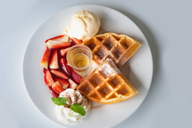 istock Fresh waffles with ice cream and maple syrup 907564928