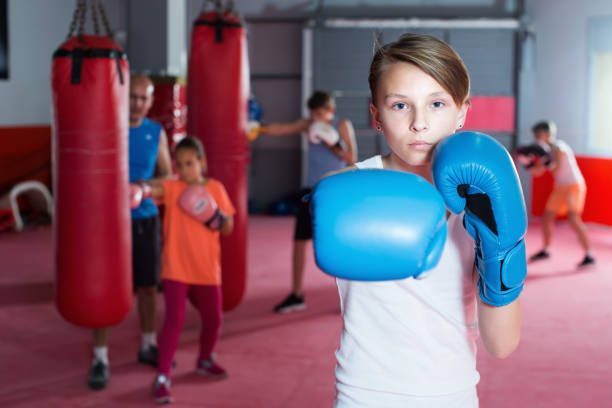istock Boxer in gloves posing during boxing exercising 907564952