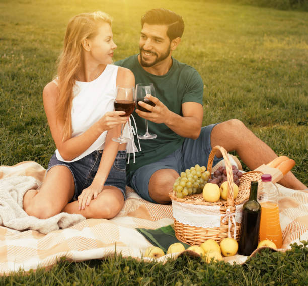 istock Couple are talking sitting and drinking wine 907571350