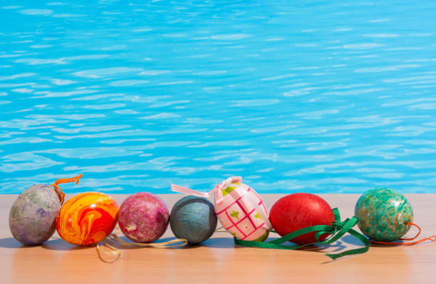 istock Easter in pool, wellness and relax. Eggs and water background for party and spa 907574474