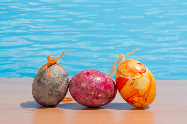 istock Easter in pool, wellness and relax. Eggs and water background for party and spa 907575150