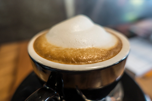cappuccino foam in a black cup