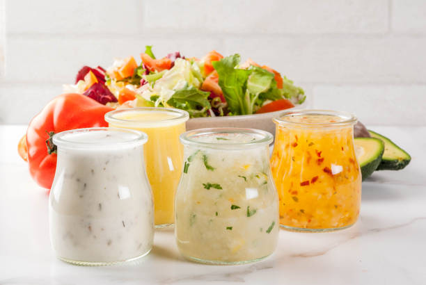 Classic salad dressings Set of classic salad dressings - honey mustard, ranch, vinaigrette, lemon & olive oil, on white marble table, copy space mustard fruits stock pictures, royalty-free photos & images
