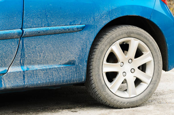 istock Road salt stains on car, winter driving concept 907582360