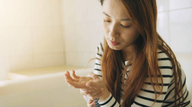 istock Woman massaging her arthritic hand and wrist 907593608