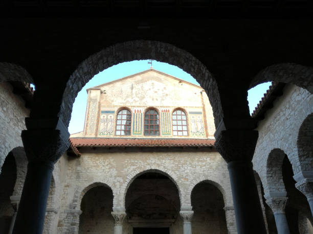 istock Ancient old church tower in Porec Croatia 907605488