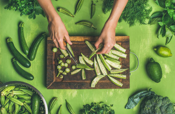 istock Woman hands cutting green vegetables and greens 907605820