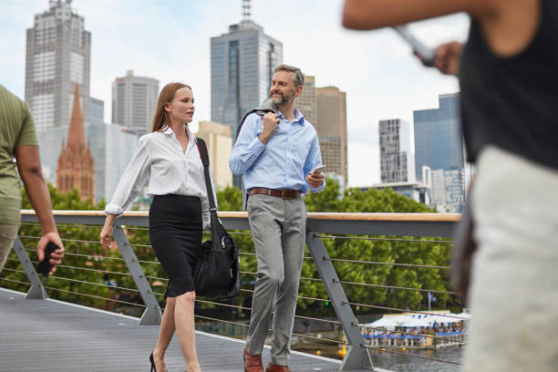 Executives talking and walking on bridge in city