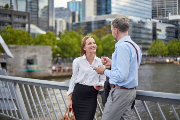 istock Business colleagues talking at bridge in city 907610358