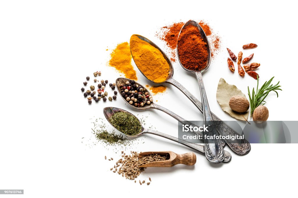 Spices And Herbs In Old Spoons Isolated On White Background Stock