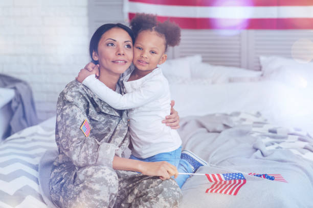 istock Joyful pleasant woman sitting with her daughter 907613984