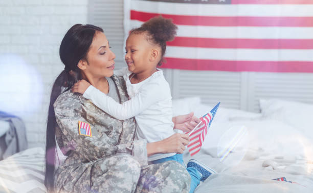 istock Positive nice mother and daughter sitting on the bed 907614048