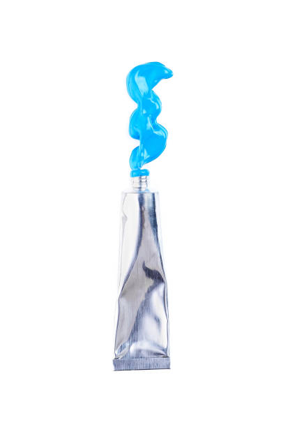 tube of blue acrylic paint on white background - primary colours imagens e fotografias de stock