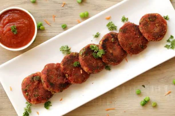 Vegetable cutlet or patties are a delicious snack made from boiled mixed vegetables. This can be eaten like that or kept inside a burger bun and served with tomato ketchup.