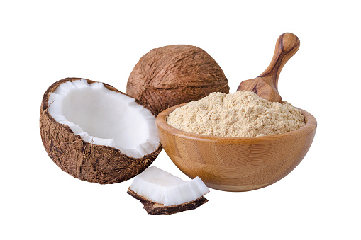 coconut flour in wooden bowl isolated on white background