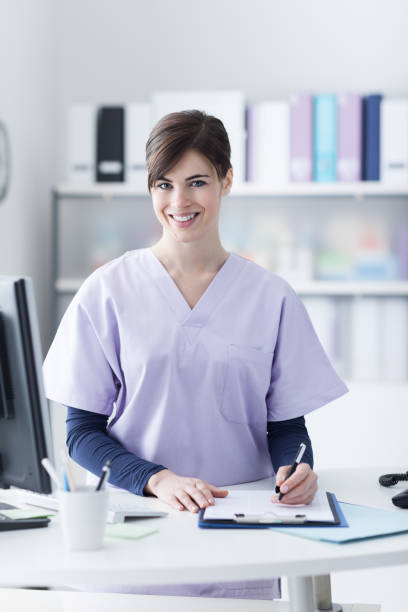 istock Smiling receptionist at the clinic 907617644