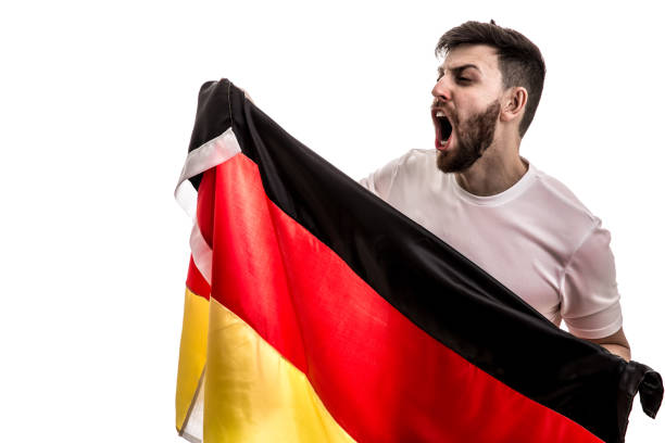 istock German male athlete / fan celebrating on white background 907618194