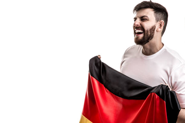 istock German male athlete / fan celebrating on white background 907618216