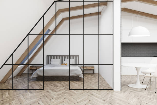 istock Attic bedroom, gray bed, wooden floor 907621748